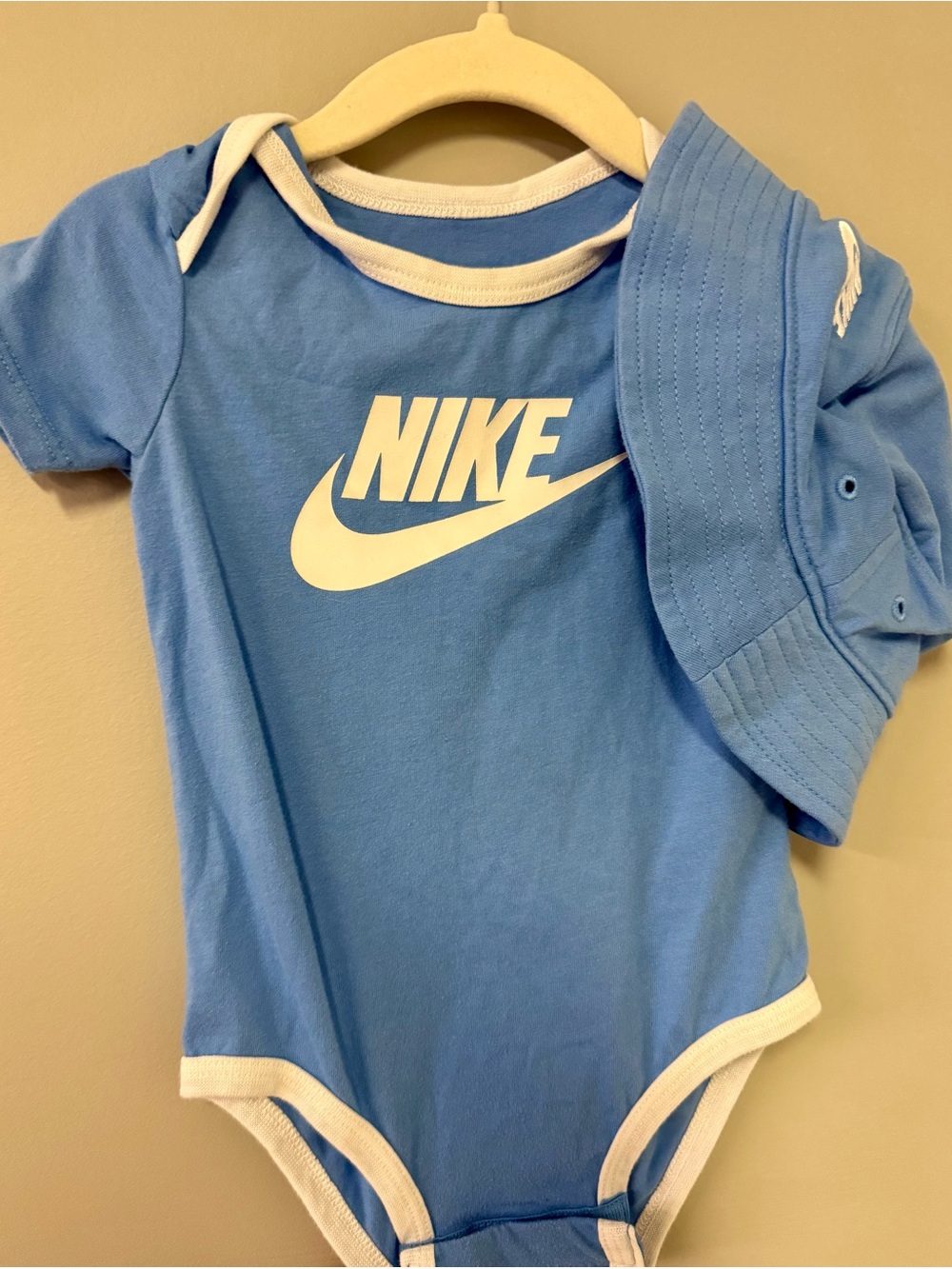 Nike Blue Baby One-Piece Bodysuit with White Trim & Matching Hat W Chin Strap.
